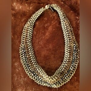 Collar necklace.
